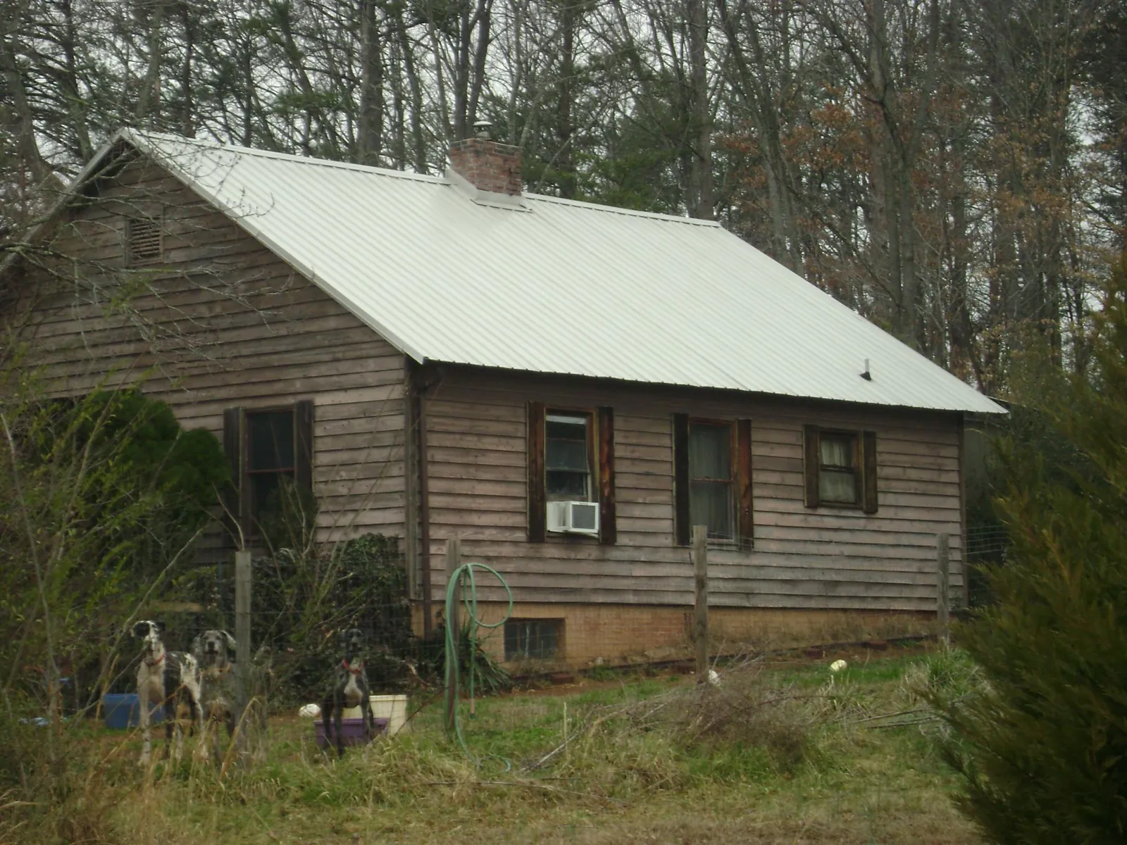 White metal roof on an old wood sided farmhouse, from a Metal Roof Installation job in Hurricane